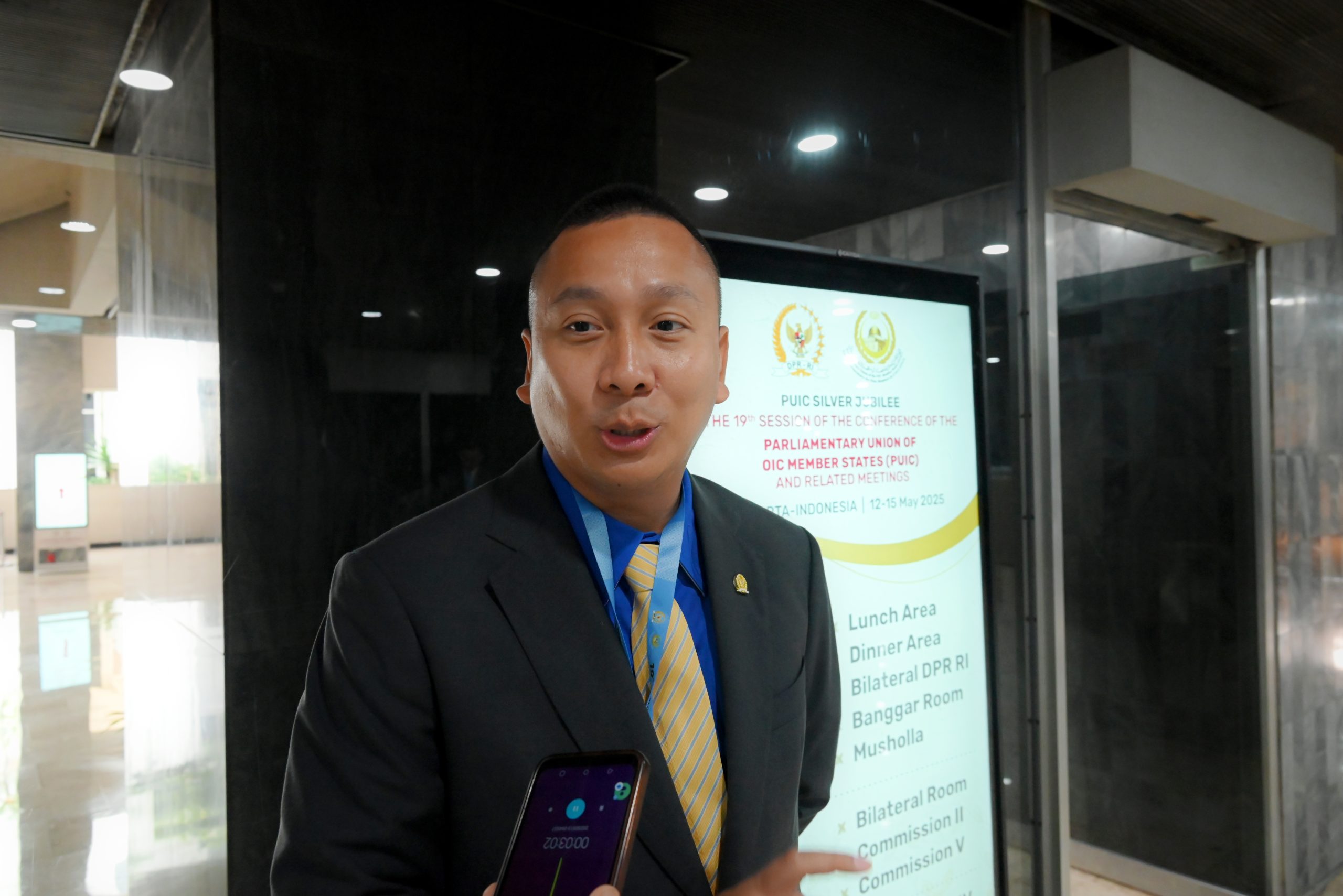 Anggota Badan Kerja Sama Antar-Parlemen (BKSAP) DPR RI, Galih Dimuntur Kartasasmita, saat diwawancara usai mengikuti 11th Meeting of the Specialised Standing Committee on Economic Affairs and the Environment, bagian dari Konferensi ke-19 Parliamentary Union of the OIC Member States (PUIC), di Gedung Nusantara, DPR RI, Senayan, Jakarta, Selasa (5/13/2025). Foto: Mentari/vel.